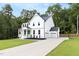 Lovely exterior elevation showing the home's architecture, three-car garage, basketball hoop and large driveway at 720 The Parks Dr, Pittsboro, NC 27312