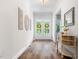 Welcoming foyer featuring wood floors, decor, console table, and bright double doors at 720 The Parks Dr, Pittsboro, NC 27312