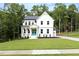 Charming two-story home with a bright blue front door, covered porch, and beautifully landscaped front yard at 720 The Parks Dr, Pittsboro, NC 27312