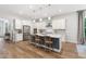 Elegant kitchen featuring a large island, stainless steel appliances, and modern lighting fixtures at 720 The Parks Dr, Pittsboro, NC 27312
