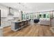 Bright, open-concept kitchen with stainless steel appliances, a large island, and seamless flow to the living area at 720 The Parks Dr, Pittsboro, NC 27312