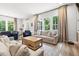 Spacious living room filled with natural light and views of the wooded backyard at 720 The Parks Dr, Pittsboro, NC 27312