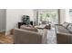 Cozy living room featuring a large window, comfortable seating, and a neutral color palette at 720 The Parks Dr, Pittsboro, NC 27312