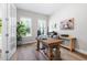 Comfortable home office with a large wooden desk, a houseplant, and natural light at 720 The Parks Dr, Pittsboro, NC 27312