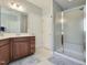 Bathroom with a glass-enclosed shower, vanity with drawers, and tile flooring at 7502 Hedfield Way, Durham, NC 27713