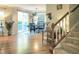 Bright dining area with a sliding glass door, access to stairs, and hardwood floors at 7502 Hedfield Way, Durham, NC 27713