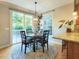 Dining area featuring a round table, sliding glass door and a stylish light fixture at 7502 Hedfield Way, Durham, NC 27713