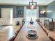 Dining room showcasing a large wooden table and stylish light fixture, complemented by hardwood floors at 7502 Hedfield Way, Durham, NC 27713