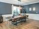Spacious dining room features hardwood floors, a modern light fixture, and plenty of seating at 7502 Hedfield Way, Durham, NC 27713