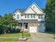 Charming two-story home features a well-manicured lawn, stone accents and a two-car garage at 7502 Hedfield Way, Durham, NC 27713