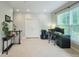 Spacious home office featuring a desk setup, a window for natural light, and carpet flooring at 7502 Hedfield Way, Durham, NC 27713