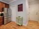Bright kitchen with stainless steel appliances, hardwood floors, and access to additional rooms at 7502 Hedfield Way, Durham, NC 27713