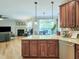 Open-concept kitchen with granite countertops, hardwood floors, and view into the living room at 7502 Hedfield Way, Durham, NC 27713