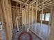 Bathroom framing with plumbing fixtures and window placement, showing construction details at 76 Tuskeegee Dr, Smithfield, NC 27577