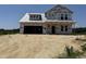 Exterior view of new two-story house construction with visible lumber and protective wrap, awaiting finishing touches at 76 Tuskeegee Dr, Smithfield, NC 27577