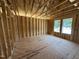 Room framing featuring two windows and open ceiling, visualizing the final layout and design at 76 Tuskeegee Dr, Smithfield, NC 27577