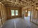 Open room framing with windows showcasing the layout and flow of the new construction home at 76 Tuskeegee Dr, Smithfield, NC 27577