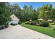 Spacious backyard with a detached garage, pool, and lush landscaping at 7713 Summercrest Dr, Apex, NC 27539