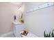 Charming powder room featuring a pedestal sink, decorative mirror, and black and white tile floors at 7713 Summercrest Dr, Apex, NC 27539