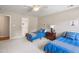 Cozy bedroom featuring twin beds, nautical decor, and ceiling fan for comfortable living at 7713 Summercrest Dr, Apex, NC 27539