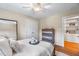 Cozy bedroom with a double closet, ceiling fan, a tray with a book, and neutral decor at 7713 Summercrest Dr, Apex, NC 27539