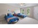 Inviting bedroom with twin beds, bright windows, and nautical decor, ideal for  at 7713 Summercrest Dr, Apex, NC 27539