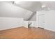 Spacious bonus room with hardwood floors, neutral walls, and a door with stairs perfect for flexible living space at 7713 Summercrest Dr, Apex, NC 27539