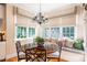 Bright breakfast nook with banquette seating and decorative chandelier at 7713 Summercrest Dr, Apex, NC 27539