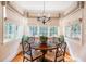 Charming breakfast nook featuring a decorative chandelier and sun-filled windows at 7713 Summercrest Dr, Apex, NC 27539