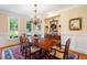 Elegant dining room featuring hardwood floors, chandelier, and large windows at 7713 Summercrest Dr, Apex, NC 27539