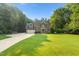 Two-story brick home featuring an attached garage and well-maintained lawn at 7713 Summercrest Dr, Apex, NC 27539