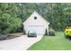 Two-car detached garage with a classic green car parked on the driveway at 7713 Summercrest Dr, Apex, NC 27539