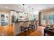 Bright kitchen featuring a long breakfast bar and stainless steel appliances at 7713 Summercrest Dr, Apex, NC 27539