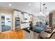 Bright kitchen with white cabinets, stainless steel appliances, and breakfast bar seating at 7713 Summercrest Dr, Apex, NC 27539