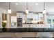Open kitchen with modern appliances, white cabinetry, granite counters and pendant lighting at 7713 Summercrest Dr, Apex, NC 27539