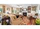 Elegant living room featuring a fireplace, built-in shelving, neutral furniture, and a vibrant area rug at 7713 Summercrest Dr, Apex, NC 27539