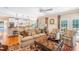 Open living space with kitchen view featuring hardwood floors, a ceiling fan and natural light at 7713 Summercrest Dr, Apex, NC 27539