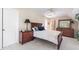 Elegant main bedroom featuring a wooden bed frame, dresser, soft carpet and a ceiling fan at 7713 Summercrest Dr, Apex, NC 27539