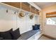 Bright mudroom with built-in storage, mud bench, and neutral decor near the back door at 7713 Summercrest Dr, Apex, NC 27539