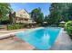 Outdoor pool featuring lounge chairs, manicured landscaping, and backyard access at 7713 Summercrest Dr, Apex, NC 27539