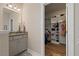 Well-lit bathroom features a vanity with granite countertop and a walk-in closet at 824 Stanly House St, Wake Forest, NC 27587