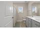 Bright bathroom featuring a double vanity, matching mirrors, and a shower with a patterned curtain at 824 Stanly House St, Wake Forest, NC 27587