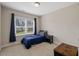 Inviting bedroom with a cozy bed, carpet flooring, and a window with neighborhood views at 824 Stanly House St, Wake Forest, NC 27587