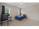 Comfortable bedroom featuring a large window, neutral walls, and stylish furnishings at 824 Stanly House St, Wake Forest, NC 27587
