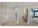 Bright hallway showcasing neutral walls, plush carpet, and doorways to bedrooms and bathrooms at 824 Stanly House St, Wake Forest, NC 27587