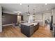 Bright kitchen with an island, pendant lighting, and an open layout connecting to the living room at 824 Stanly House St, Wake Forest, NC 27587
