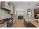Well-equipped kitchen features stainless appliances, granite countertops and a farmhouse sink at 824 Stanly House St, Wake Forest, NC 27587