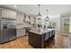 Modern kitchen with an island, stainless steel appliances, and a view of the dining area at 824 Stanly House St, Wake Forest, NC 27587