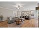 Cozy living room with a comfortable sectional, fireplace, and seamless transition into the kitchen area at 824 Stanly House St, Wake Forest, NC 27587