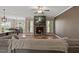 Inviting living space featuring a stone fireplace, mounted TV, and an open layout connected to the kitchen at 824 Stanly House St, Wake Forest, NC 27587